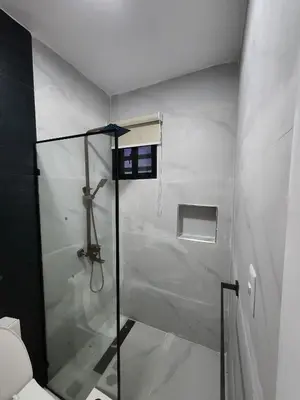 a bathroom with a shower with an umbrella in it at Villa M & M in Guerra