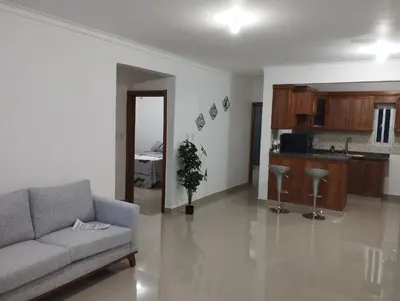 a living room with a couch and a kitchen at Alojamiento Residencial MAM in San Cristóbal
