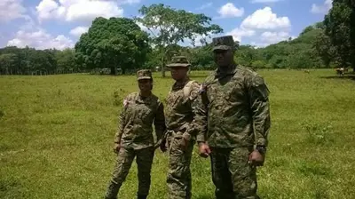 three soldiers in uniform standing in a field at Hotel 3 Hnos in Comendador