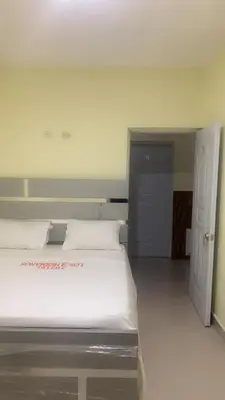 a bedroom with a large white bed in a room at Hotel 3 Hnos in Comendador