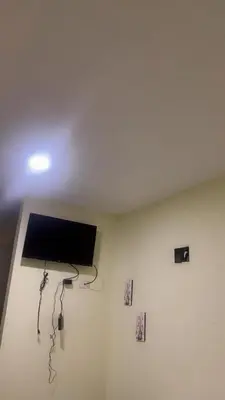 a room with a flat screen tv on the ceiling at Hotel 3 Hnos in Comendador