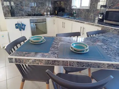 a kitchen with a table with plates on it at Dominique ugolin in Mata Chalupe