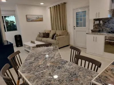 a kitchen and living room with a table and chairs at Dominique ugolin in Mata Chalupe