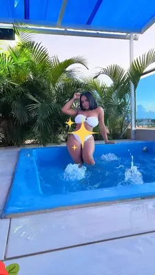 a woman in a bikini sitting in a swimming pool at Dominique ugolin in Mata Chalupe