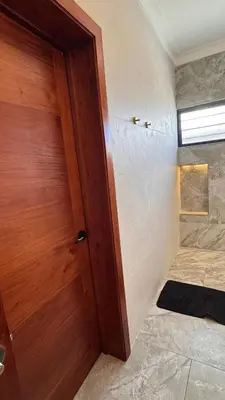 a wooden door in a room with a shower at Luxury Caribbean Oasis, Private Pool & BBQ, 8 Guest in La Romana