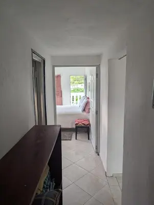 a room with a bedroom with a bed and a table at small apartment in a downtown area in Cruce de Veragua