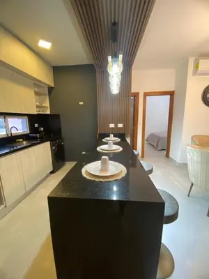 a kitchen with a black island in a room at Luxury apto 3 rooms Mariel III at White Sand, Punta Cana in Punta Cana