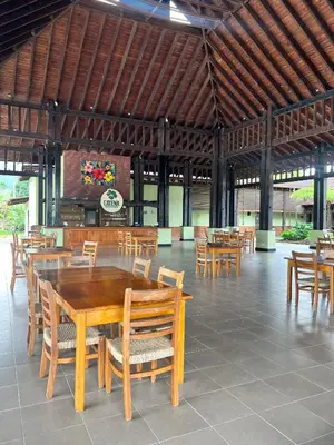 a dining room with wooden tables and chairs at Estaciones de Jarabacoa - Mountain Lodge in Jarabacoa