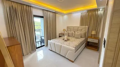 a bedroom with a white bed and a balcony at 3BR Condo by the Airport Pool Gym Parking Security in Santiago de los Caballeros