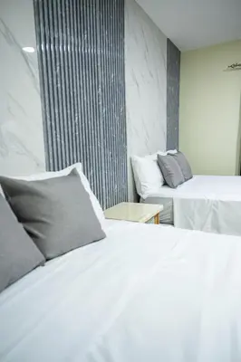 a hotel room with two beds and a window at Hotel Monterio in Azua