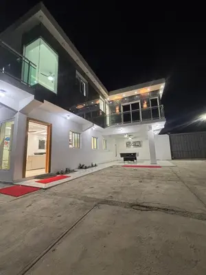 a large white house with a driveway at night at villa la pal de 4 in La Ureña