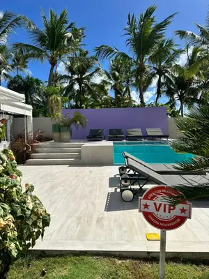 a villa with a swimming pool and palm trees at 1BR Tracadero Lodge, beach access & full amenities in La Laguna