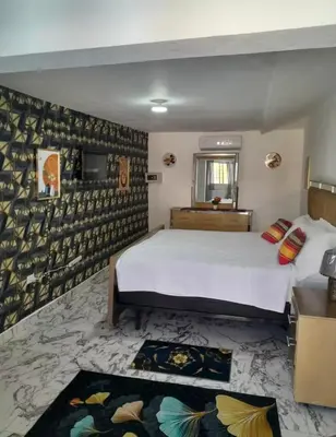 a bedroom with a large white bed in a room at Villa Us Open in Sosúa