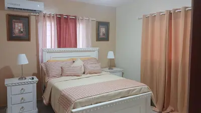 a bedroom with a bed and a window with curtains at Residencial Altos de Alameda in Peralejo