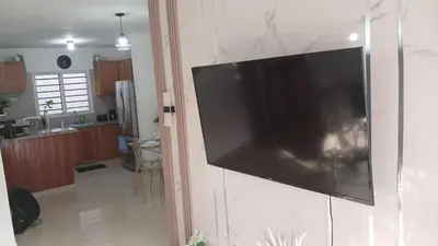 a flat screen tv hanging on a wall in a kitchen at Residencial Altos de Alameda in Peralejo