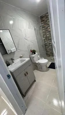 a white bathroom with a sink and a toilet at Spacious 3BR Getaway in Santiago