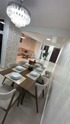 a dining table and chairs in a living room at Spacious 3BR Getaway in Santiago