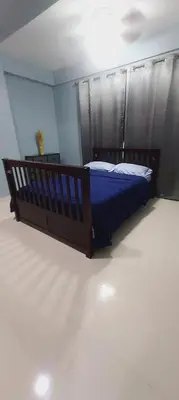a bedroom with a bed with a blue comforter at Cozy & Charming in Santo Domingo