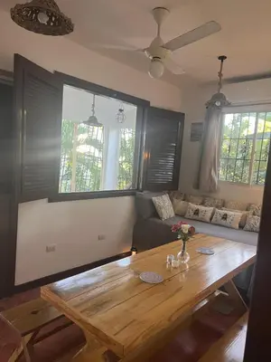 a living room with a wooden table and a couch at La Española JW in Las Galeras