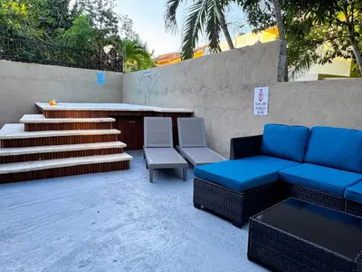 a patio with chairs and a bench and stairs at Haven Villa Retreat Jacuzzi Oasis for 16 in Mata los Indios
