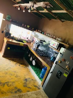 a kitchen with a counter and a sink and a refrigerator at Villa el privilegio in Jarabacoa