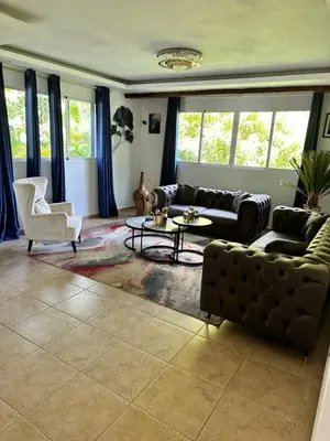 a living room with a couch and a table at Villa Robilu