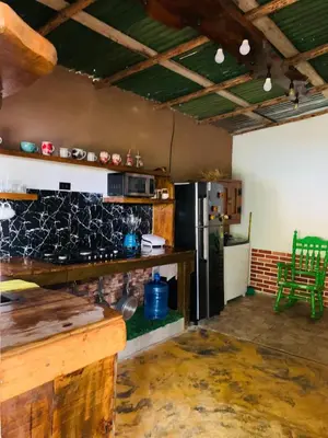 a kitchen with a stove and a refrigerator at Villa el privilegio in Jarabacoa