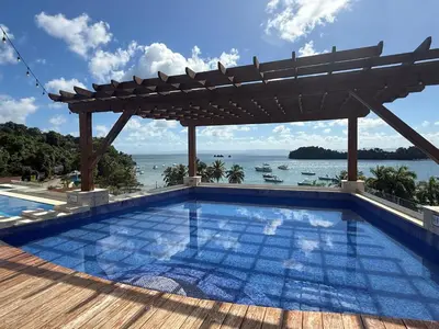 a swimming pool with a pergola and the ocean at Modern Oceanview Retreat with Balcony and Walk to Bay in Santa Bárbara de Samaná