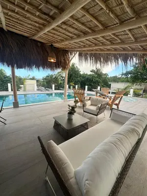 a living room with a couch and chairs and a pool at SunSeaBeach Villa Iguana - 3 SZ - Strandnähe in Las Galeras