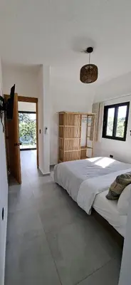 a bedroom with a large bed and a window at SunSeaBeach Villa Iguana - 3 SZ - Strandnähe in Las Galeras