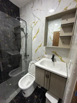 a bathroom with a sink and a toilet and a mirror at EG suits rentals in San Felipe de Puerto Plata