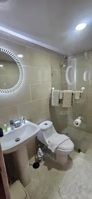 a bathroom with a sink and a toilet and a mirror at Rob's Place in Mendoza