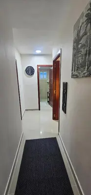 a hallway with a door and a rug on the floor at Rob's Place in Mendoza