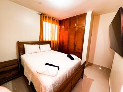 a bedroom with a bed with a bag on it at Serene Penthouse near Homs Hospital in El Ejido