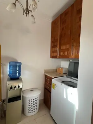 a kitchen with a refrigerator and a microwave at Caribbean luxury in Sosúa