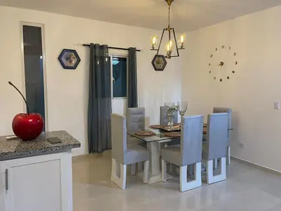 a dining room with a table and chairs at Byk 2 in Nagua