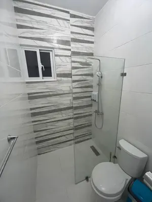 a bathroom with a toilet and a glass shower at Byk 2 in Nagua