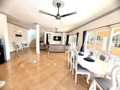 a living room with a table and chairs at Villa Tropical Cabarete in Sosua