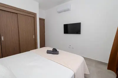 a bedroom with a bed with a hat on it at Elegant Coastal Escape Spacious 2BR Bayahibe in San Rafael del Yuma