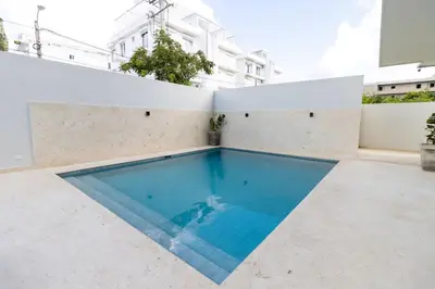 a swimming pool on the roof of a building at Elegant Coastal Escape Spacious 2BR Bayahibe in San Rafael del Yuma