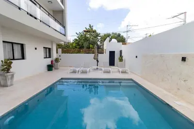 a swimming pool in the backyard of a house at Elegant Coastal Escape Spacious 2BR Bayahibe in San Rafael del Yuma