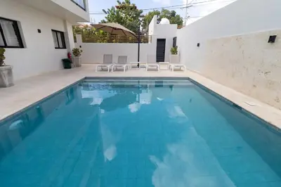 a swimming pool with blue water in a house at Elegant Coastal Escape Spacious 2BR Bayahibe in San Rafael del Yuma