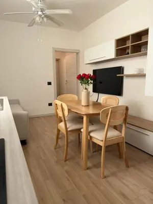a dining room with a table and chairs and a tv at Paradiso Italia Miches in Miches