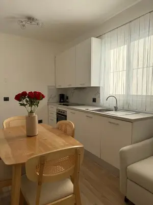 a kitchen with a table with a vase of flowers on it at Paradiso Italia Miches in Miches