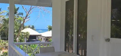 a balcony with a view of the ocean from a house at El Pelicano Apart-Hotel in Las Galeras