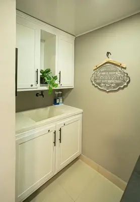 a white bathroom with a sink and a mirror at The Jade Lodge 2BR Apartment- Enjoy the nature in Puerto Plata