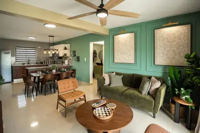 a living room with a couch and a table at The Jade Lodge 2BR Apartment- Enjoy the nature in Puerto Plata