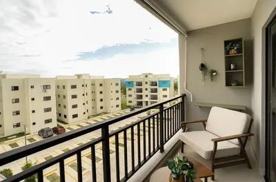 a balcony with a white chair and a large window at The Jade Lodge 2BR Apartment- Enjoy the nature in Puerto Plata