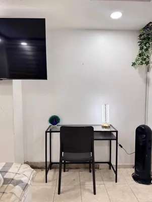 a black table with a chair in a room at Estudio Elegante 10 minutos del Monumento & Agora mall in Santiago de los Caballeros