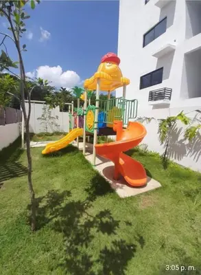 a playground in the yard of a building at Tranquilo y acogedor in Santiago de los Caballeros